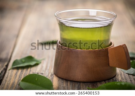 Cup of green tea on rustic wooden table