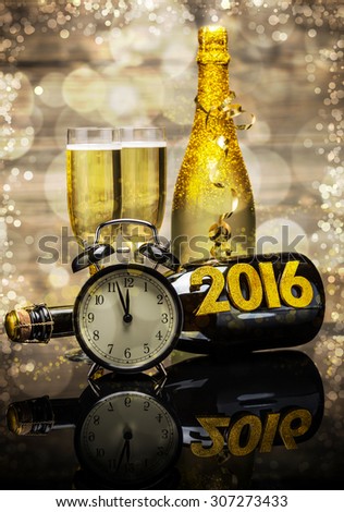2016 New Year concept with the date in numbers, clock and bottle of champagne