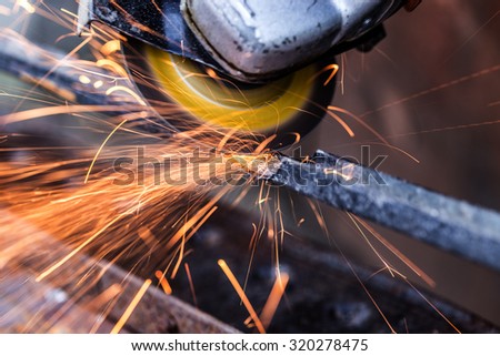 Sparks from grinding machine in workshop. Industrial background, industry.