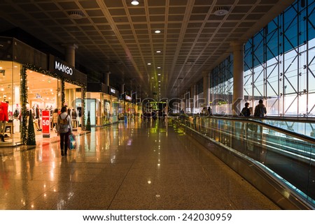 BARCELONA, SPAIN - JANUARY 05, 2015: Passengers walking in an airport terminal. El Prat airport in Barcelona