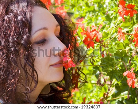 beautiful romantic woman with smelling red flower