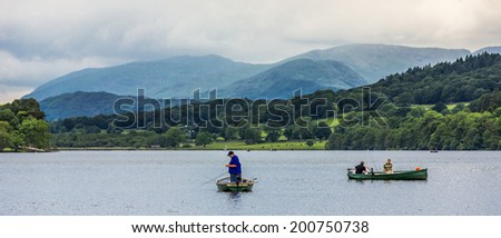 Windermere, England - June 14: Small boats on lake Windermere, on June 14, 2014, in Windermere, Lake District, England. Windermere is the largest natural lake in England.