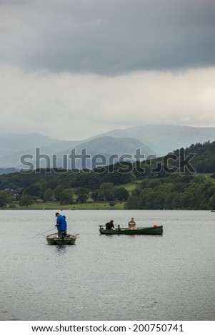 Windermere, England  - June 14: Small boats on lake Windermere, on June 14, 2014, in Windermere, Lake District, England. Windermere is the largest natural lake in England.