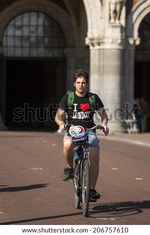 Amsterdam, Netherlands - June 29: a man riding a bicycle in Amsterdam, Netherlands on June 29, 2014.