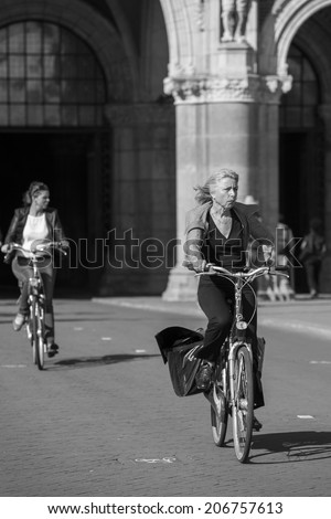Amsterdam, Netherlands - June 29: People riding bicycles in Amsterdam, Netherlands on June 29, 2014.