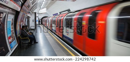London, England - October 15: Train departing a London Underground station on October 15, 2014.