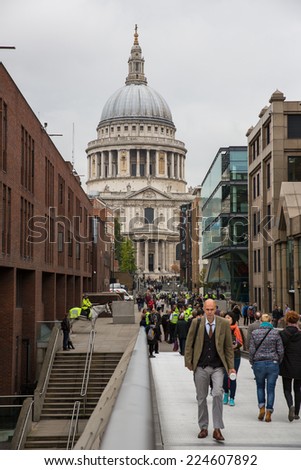 London, England - October 15: Tourists crossing the Millennium Bridge linking the City of London with the South Bank in London, England on October 15, 2014.