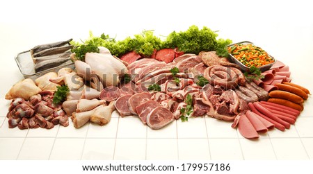 A display of various meats including chicken, steak, beef, fish, deli meats and boerewors on a white studio background