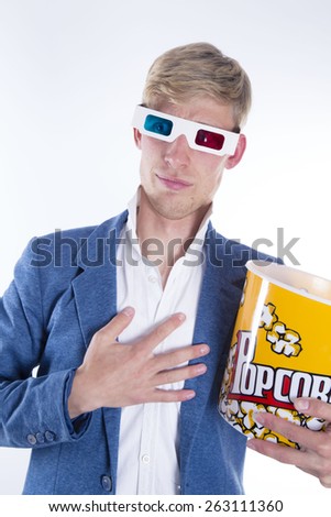 Man with popcorn watching television on white background