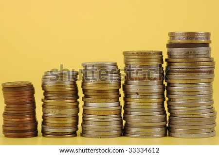 Foreign coins on yellow background