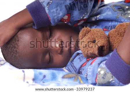 Sick child sleeping with his teddy bear