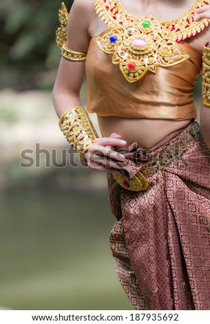 Asian girl in Thai traditional dress on action supermodel.