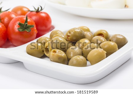 Pickled olives with fresh tomatoes on a tray