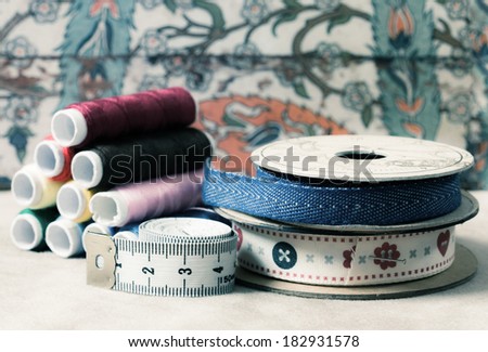 Colored Vintage Background with sewing tools and decorative tapes