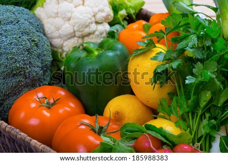 fresh vegetables tomatoes, broccoli, cauliflower lemons peppers and parsley
