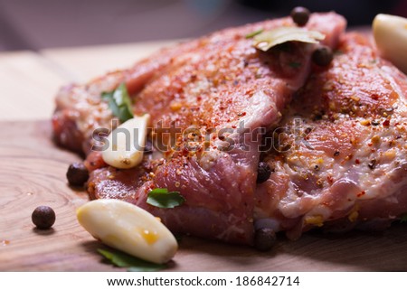 Fresh pork ribs, meat marinated and prepared for roast with garlic parsley allspice