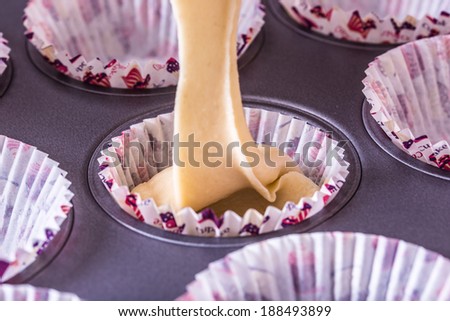 Pouring cake mix into pan. Making vanilla muffin and preparing cupcakes.