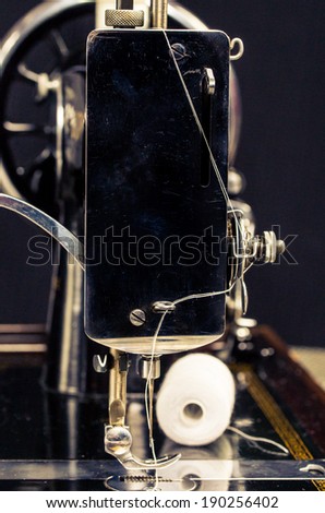 Vintage retro sewing machine on a black background