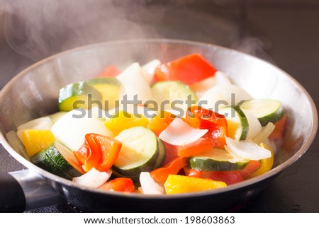 Simmering mixed vegetables on frying pan