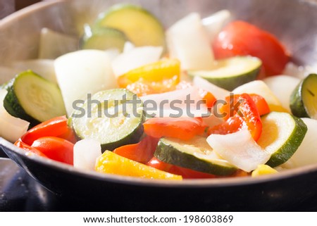 Simmering mixed vegetables on frying pan