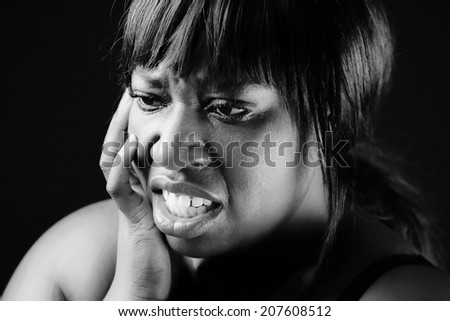 Young African woman acting as someone in pain or sad