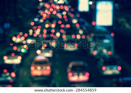 abstract traffic jams night light with cross process filter background with blurry shallow depth of focus.