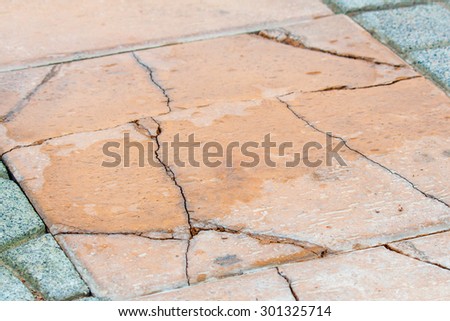 closed up crack gray concrete block pavement walkway has broken from problem construction