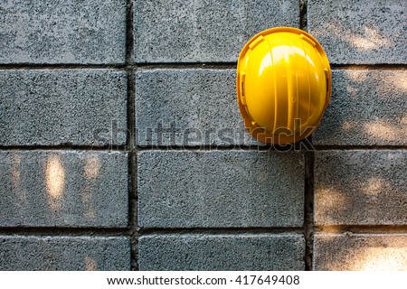 view yellow Safety Engineer Helmet ,with new concrete block wall background