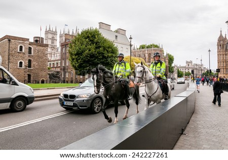 LONDON, ENGLAND - SEPTEMBER 15, 2013:  The Metropolitan Police with special police horses to keep the crowds under control, they sauntering around London