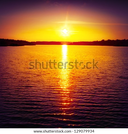 Colorful sunset over water surface.