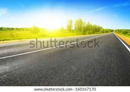 Empty asphalt road on bright summer day.