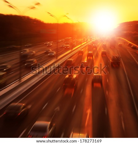 Cars In Motion Blur On Highway During Sunset.