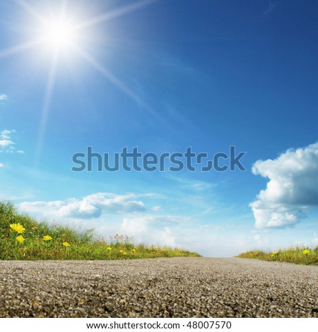 Rural road,blue sky and sun.