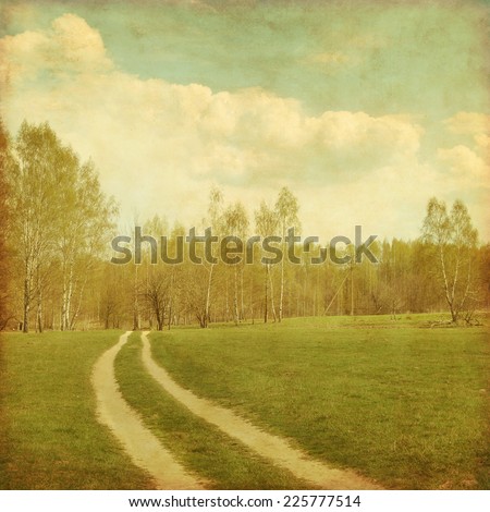 Country road to forest in grunge and retro style.