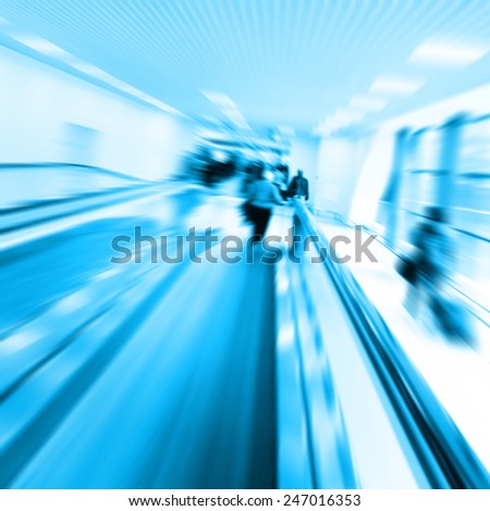 Group of people in motion blur walking in metro station.