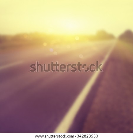 Abstract blurred background of country road at sunset.