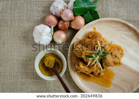 Indian food with curry powder and ingredients on the sackcloth background
