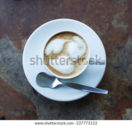 Hot coffee patterned on a wood table