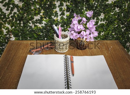 Pen Box, notebook, glasses and vase in wood table ,Still life