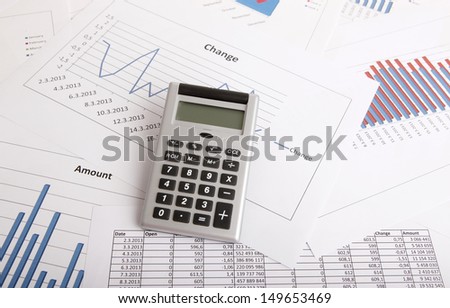 A business strategy concept with a calculator and color charts
