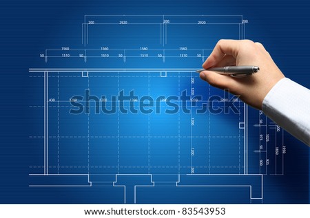Hand and blueprint - engineer working on blue print concept