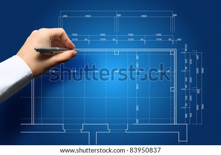 Hand and blueprint - engineer working on blue print concept