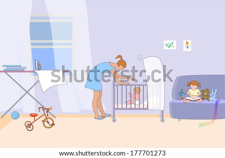 Young mother plays with baby in room. Other child looks at a book on the couch near toys.