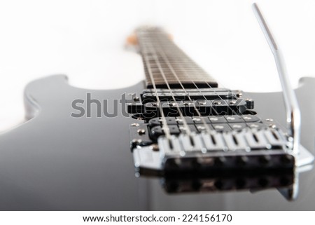 Black Electric Guitar strings and pickup closeup