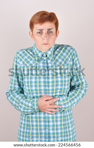 Woman with abdominal pain holding her stomach