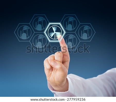 Index finger of a white collar worker selecting wind power generation over nuclear energy by touch. Business and technology metaphor for energy turn or Energiewende. Close up. Blue background.
