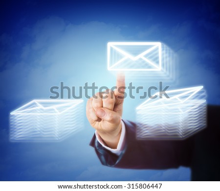 Right hand of a white collar worker is busy moving email between two stacks of mail documents. Business concept for overtime, work load, efficiency, overwhelming task, throughput and administration.