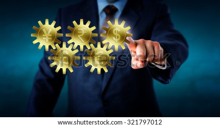 Five major currencies interlocking like a gear train. Golden cogs embossed with Dollar, Euro, Rupee, Pound Sterling and Yen or Yuan symbol. Hand of a trader is touching and highlighting the Dollar.