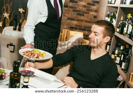 Waiter serving food to a customer