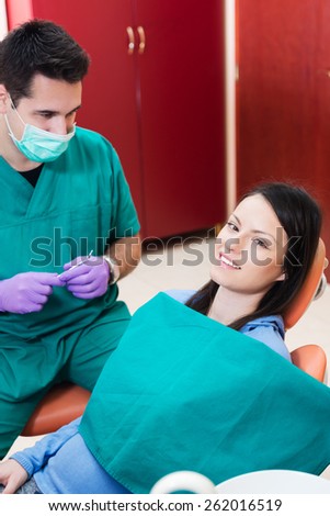 Image of smiling patient looking at camera at the dentist office
